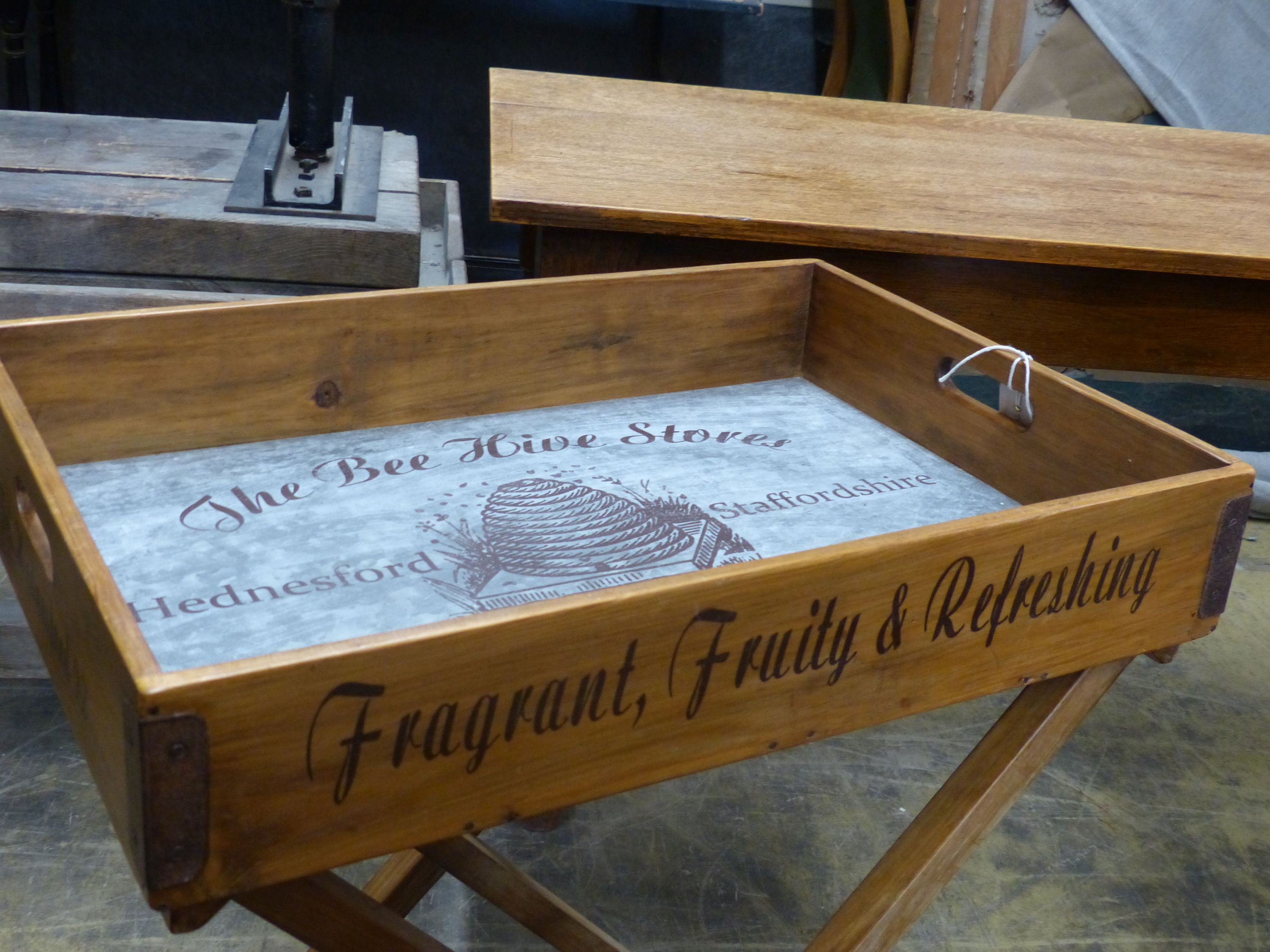 'The Bee Hive Stores', a rectangular wooden produce display tray on folding stand, width 65cm, depth 44cm, height 78cm